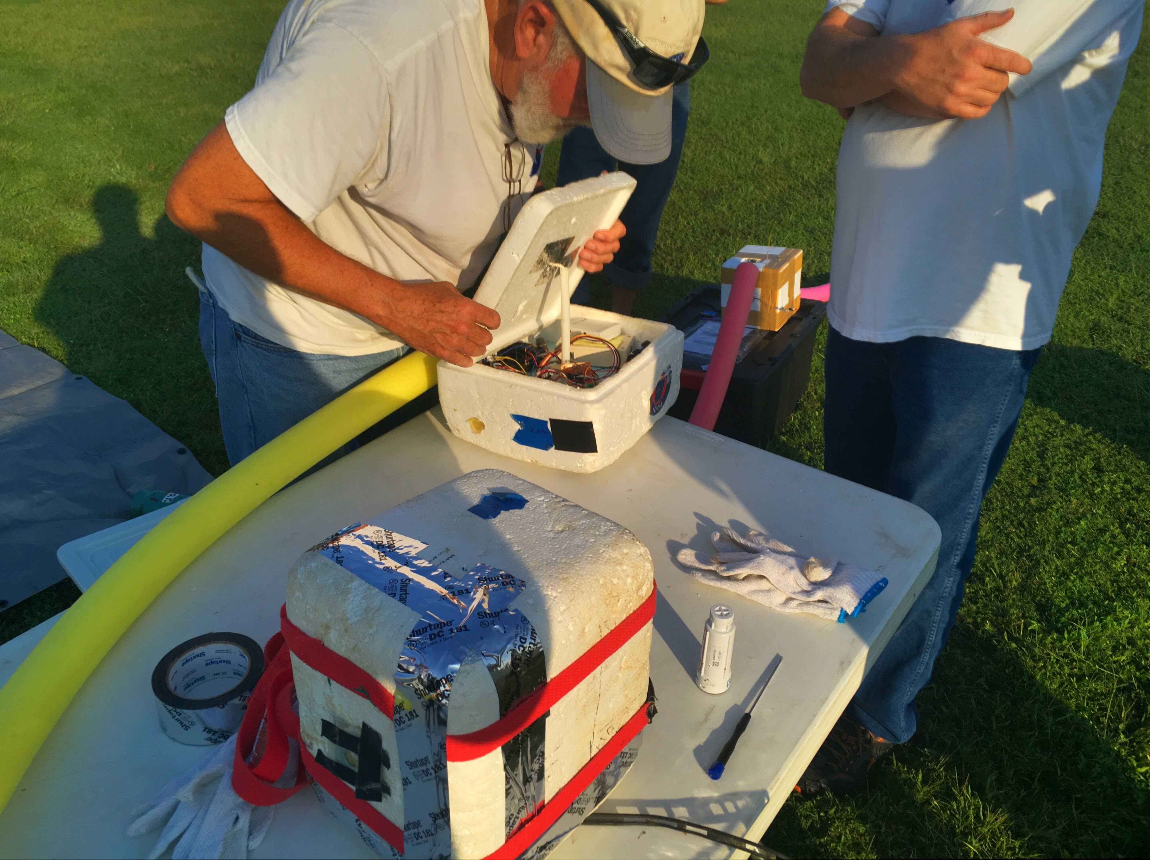 Prof. Tillman Kennon & Arkansas BalloonSAT preparing payload boxes for launch.